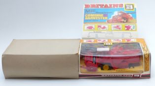 Britains diecast model Massey Ferguson Combine Harvester with red body and reel and yellow hubs