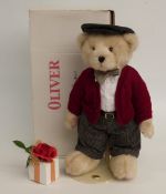 The Danbury Mint Teddy bear Oliver with blonde mohair, tartan trousers, red cardigan and flat cap,