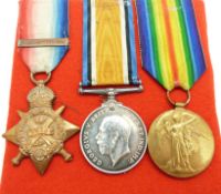 British Army WWI medals comprising 1914 'Mons' Star with clasp, War Medal and Victory Medal, named