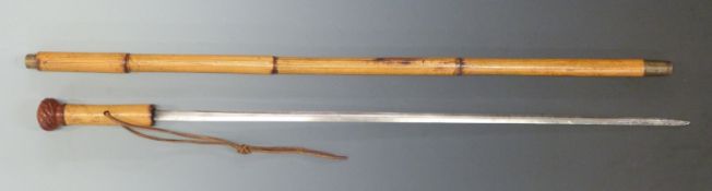 A 19thC bamboo sword stick with carved knop, brass end and collar and a 65cm blade.