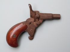 Percussion hammer action pocket or muff pistol with shaped wooden grips and 1.5 inch part