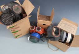 WWII two civilian gas masks together with a small child's boxed example