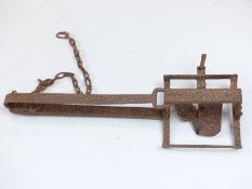 A 19thC man / bear trap of iron construction with single spring loaded mechanism and original