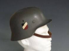 WWII German steel helmet with two decals, leather liner and chin strap