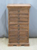 A hardwood chest of nine straight drawers with loop handles, W52 x D37 x H90cm