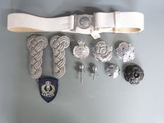 A small collection of police uniform and helmet accessories including helmet plate for South Wales