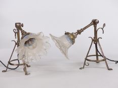 Two articulated wall mounted possibly railway or ship's lights with floral glass shades, height