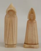 A pair of early Nordic carved walrus ivory chess pieces in the form of hooded monks, 5.7cm tall