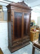 19th century continental carved oak cabinet with carved mask and fruit decoration to pediment,