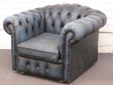 A blue leather Chesterfield armchair. W104 x D90 x H68cm