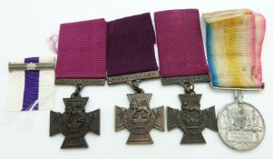 Three Victoria Cross replicas together with a copy Military Cross bar and copy Defence of Kelat-i-