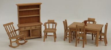 A set of wooden doll's house furniture comprising hand-crafted dining set, dresser, rocking chair