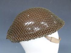 British Army WWII 'Brodie' steel helmet dated 1939 in brown with liner helmet and net