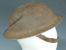 British Army WWII 'Brodie' steel helmet with liner and chin strap, the rim stamped JSS127 I 1939,