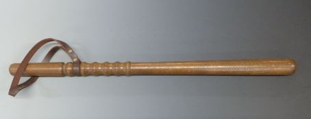 A graduated wooden truncheon with leather wrist strap, 66cm long.