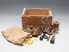 A collection of shotgun cartridge re-loading tools and accessories including crimpers, cappers/de-