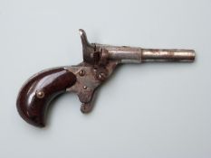 Blank firing .22 hammer action muff pistol with mottled Bakelite grips and 2.25 inch part