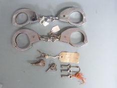 Two pairs of Hiatt 1960's handcuffs together with a similar collection of handcuff keys
