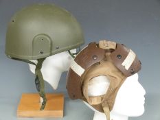 A flight deck crewman's helmet with cranial shields and a Mk6 combat helmet