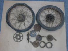 Two vintage motorbike wheels and a quantity of brake and hub parts