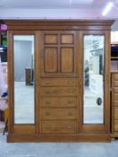 19th century inlaid mahogany wardrobe with two bevelled mirrored doors either side of a cupboard