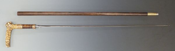 A 19thC sword stick with yellow metal mounts and deer horn handle and 71cm fullered blade.