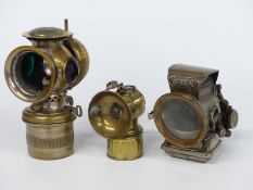 Three vintage motorcycle or similar lamps including Solar and Lucas Silver King