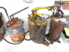 Two vintage oil dispensers, one marked Regent Oil Co Ltd and a Fina grease dispenser