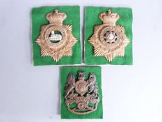 Three British Army helmet plates, East Yorkshire, East Lancashire and Royal Artillery