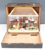 Perspex / acrylic dolls house or exhibition house with similar scale model furniture and people.