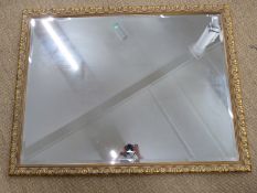 Ornate bevelled glass mirror. 103 x 134cm, and a table lamp