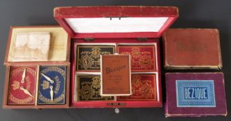 Five cased / boxed Bezique playing card sets including De La Rue leather cased set with markers