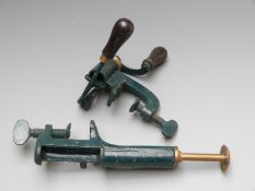 Two 12 bore steel and brass shotgun cartridge reloading tools.
