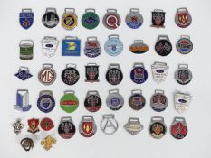 Approximately 40 enamel classic car keyring badges including Riley, Mini Cooper, Taylor's Gloucester