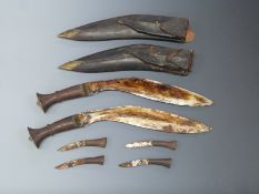 Two Kukri knives in leather sheaths with side arms