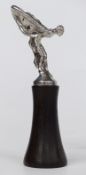Rolls Royce Spirit of Ectasy car mascot raised on wooden base, height of mascot 12.5cm