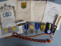A collection of Dutch Army memorabilia from WWII relating to Hijman Roet. Includes a cap badge for
