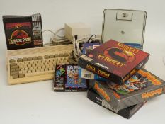 Commodore A600 Amiga games console together with joystick and various games including Mortal Kombat,