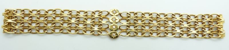 An 18ct gold oval link bracelet set with four old cut diamonds in star settings, 43.8g