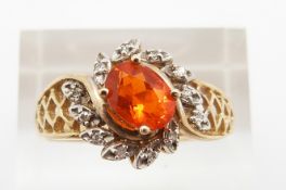 A 14ct gold ring set with an oval cut fire opal and diamonds, 4.1g, size T
