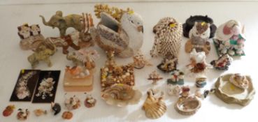 A collection of sculptures and pictures, all made up of shells.