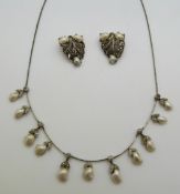 A necklace set with marcasite and blister pearls together with matching clips