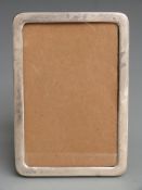 George V hallmarked silver photograph frame to suit 5.5x3.5 inch photo, with wooden easel back,