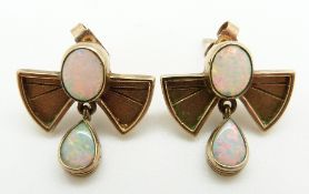 A pair of 9ct gold earrings each set with two oval opals