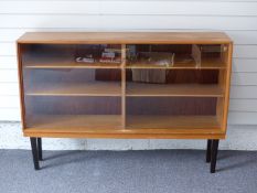 Gordon Russell of Broadway bookcase with sliding glass doors, W138 x D30 x H95cm