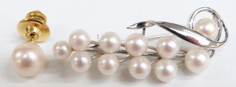 A naturalistic pearl brooch marked silver, length 50mm and a pearl tie pin