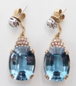 A pair of 14ct gold earrings set with a mixed cut aquamarine (measuring approx 7.6ct) and diamonds