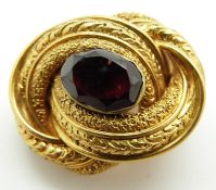 Victorian knot brooch with embossed textured design set with a foiled garnet, 7.7g (2.3 x 1.6cm)