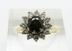 An 18ct gold ring set with a round cut tourmaline surrounded by diamonds, 3.7g, size O