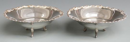 Pair of Italian white metal bowls with flared and foliate rims, raised on three scroll feet, with